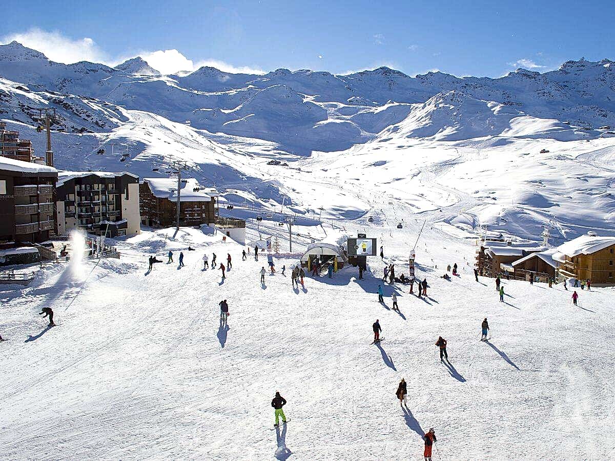 overhead view of skiers heading down a snowy mountain at a vegan friendly ski resort on a bright and sunny day