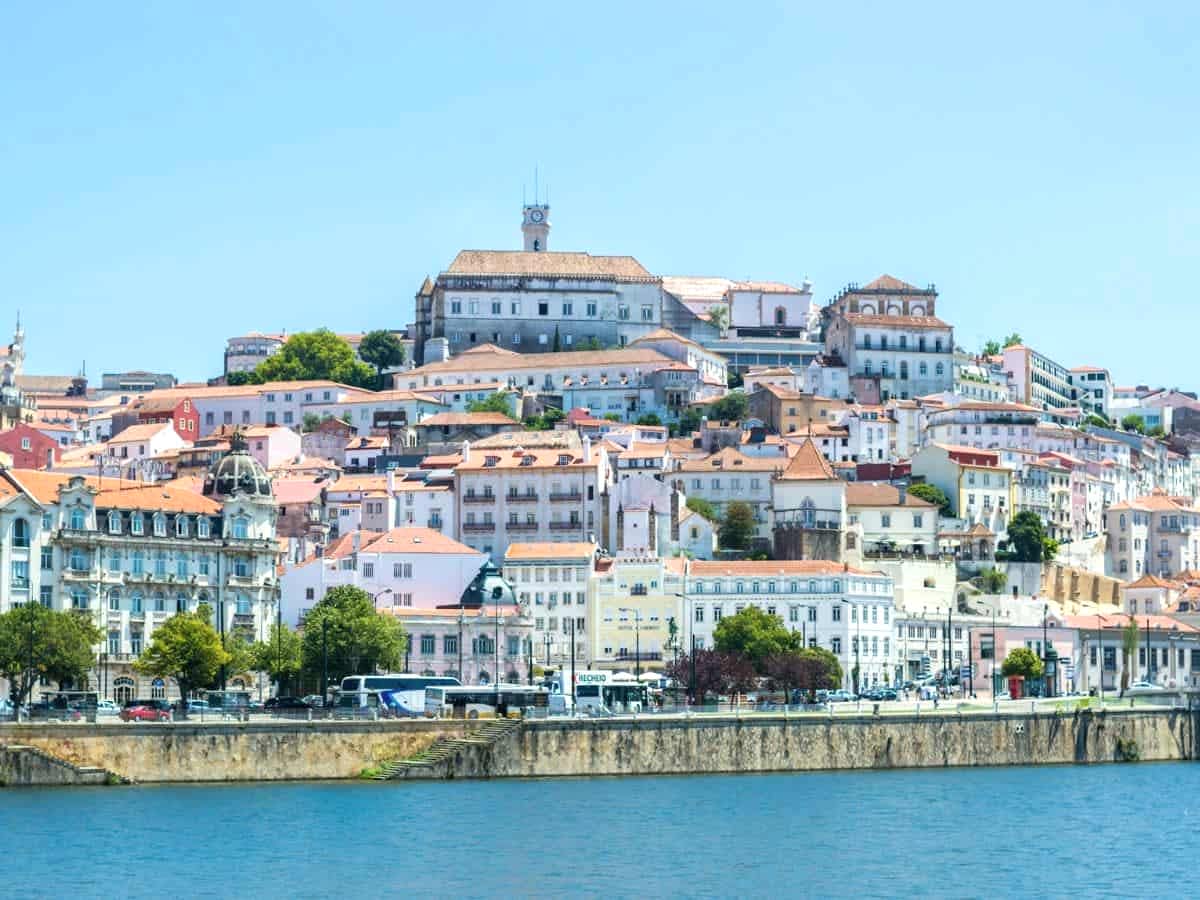 city view of coimbra from across the river on a partly cloudy day